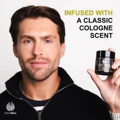 Man holding a jar of Crazy Bull Bull Blaster Water Pomade with text about a classic cologne scent on a white background.